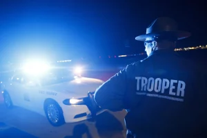 A highway patrol trooper surveys traffic